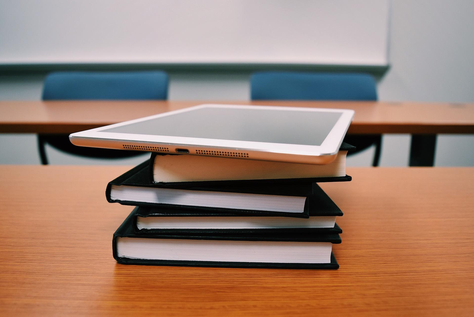 Books and a tablet computer. Illustrative. Books and a tablet computer. Illustrative.