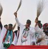 General_Buhari_holding_a_broom_at_a_campign_rally_0